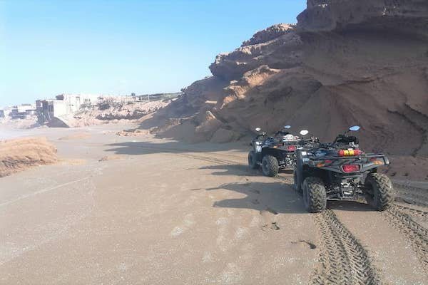 Quads on the beach at the foot of the cliffs