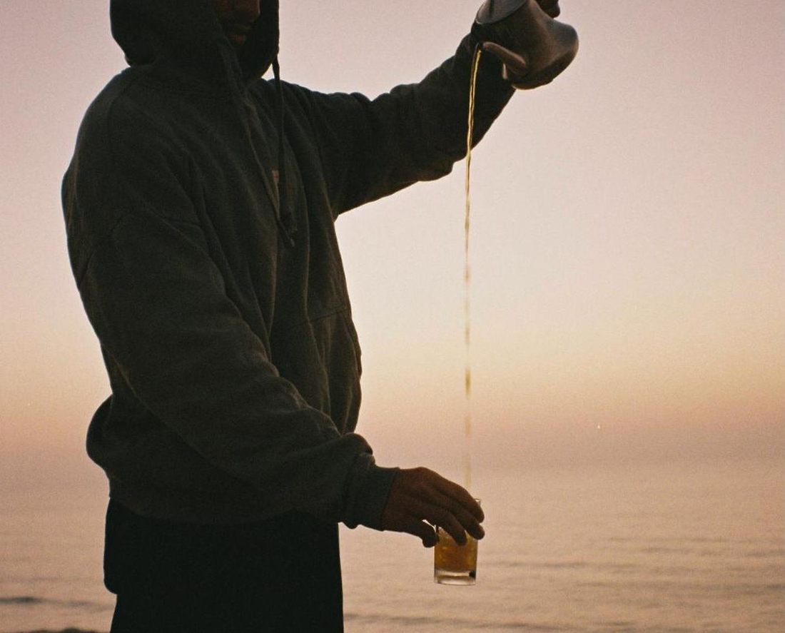 Silhouette pouring Moroccan tea from a height at sunset